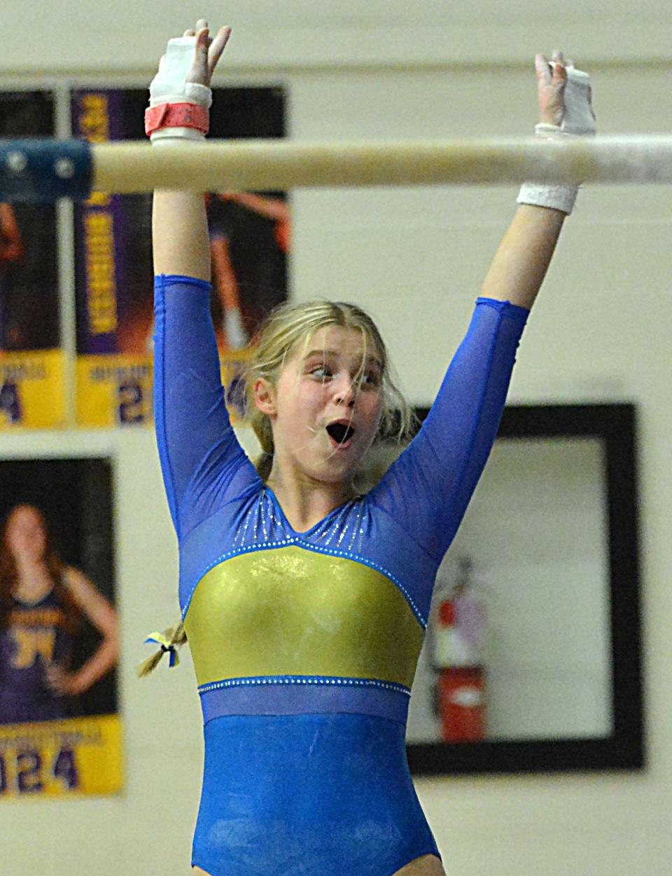 Aberdeen Central's Alexis Bomesberger looks on in amazement after sticking her landing from the uneven bars during a high school gymnastics triangular on Thursday, Jan. 25, 2024 in the Watertown Civic Arena.