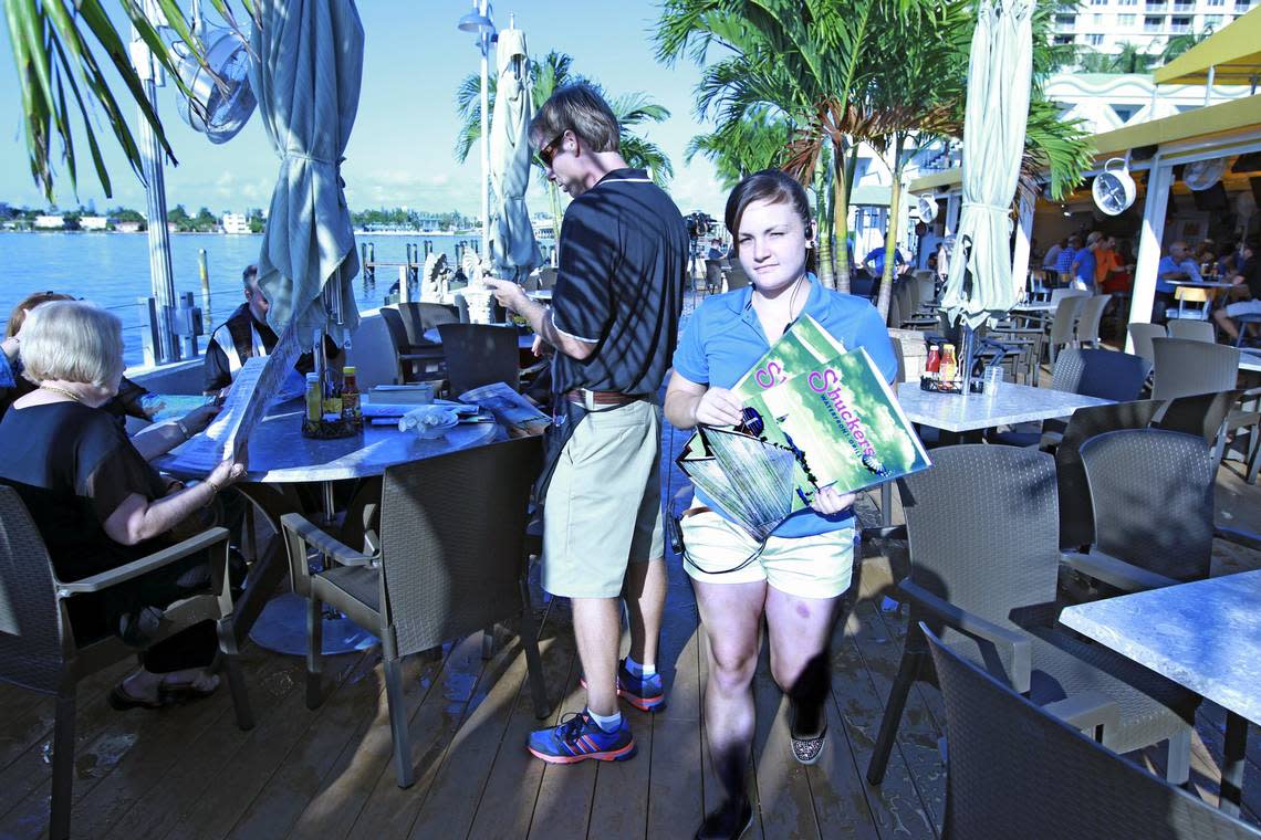 Hostess Carley Lenon walks along the newly constructed deck at Shuckers in North Bay Village. Shuckers, the bayfront bar and grill where a deck collapsed sending dozens of people into the water in 2013 while customers watched a Miami Heat game. This photo is from the day of reopening, July 23, 2014.