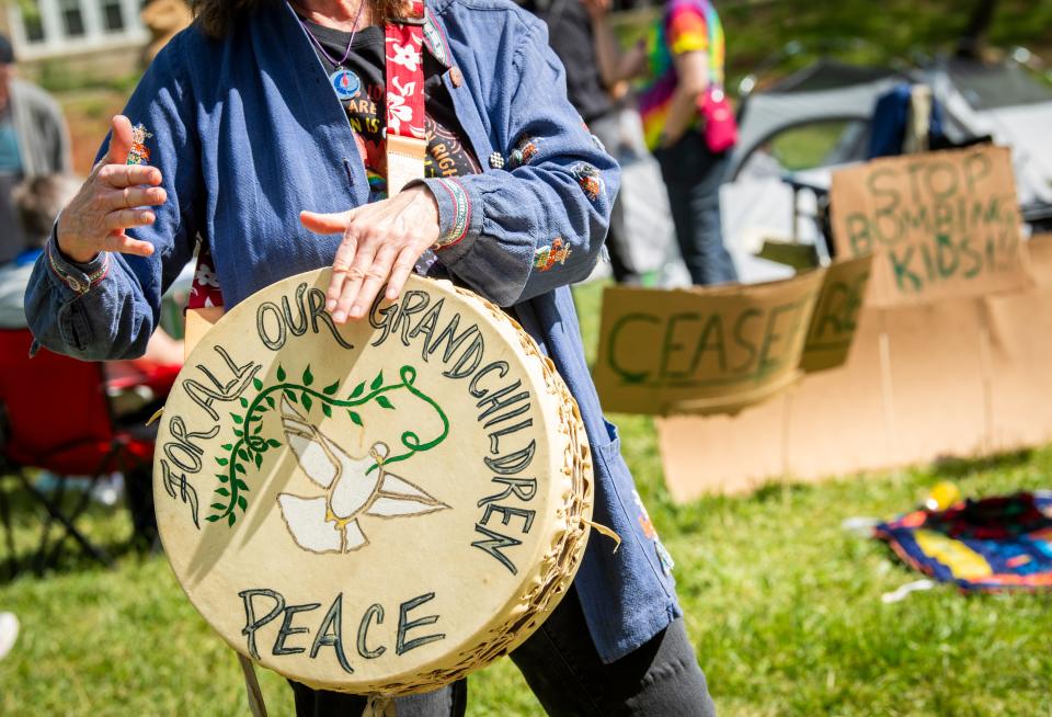 Glenda Breeden plays a drum in Dunn Meadow on Tuesday, April 30, 2024.