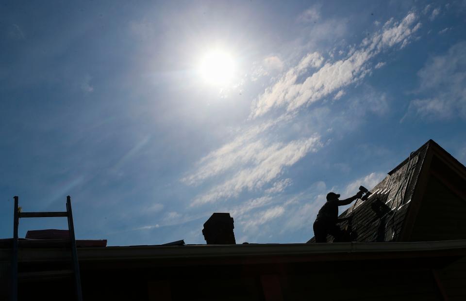 A worker from Duro Roofing put on shingles atop a home in New Albany under a blazing sun and sweltering temperatures Monday afternoon. A thermometer registered 95 degrees but a "Feels Like" gauge showed a stifling 108 degrees. More hot weather is predicted throughout the rest of the week, with highs up to 98 degrees.