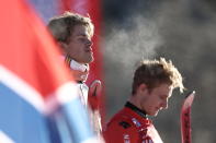 The winner Norway's Lucas Braathen and third placed Switzerland's Marco Odermatt are framed by a Norwegian flag after an alpine ski, men's World Cup giant slalom, in Alta Badia, Italy, Sunday, Dec. 18, 2022. (AP Photo/Gabriele Facciotti)