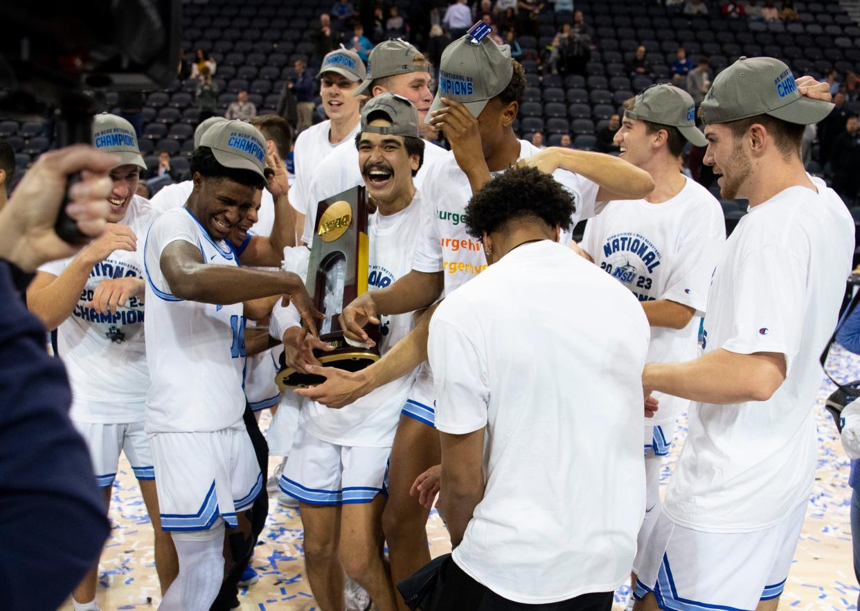 The Nova Southeastern University Sharks celebrate their victory over the West Liberty Hilltoppers during the championship game of the 2023 NCAA Division II Men’s basketball tournament at Ford Center in Downtown Evansville, Ind., Saturday afternoon, March 25, 2023. 