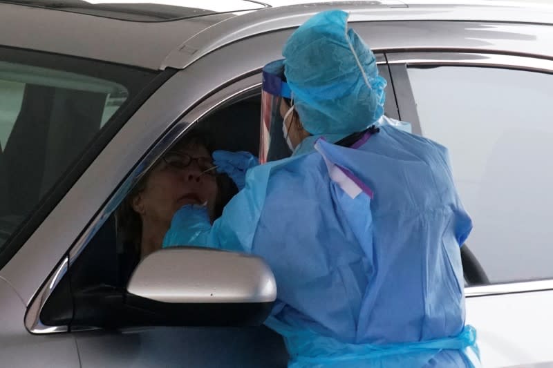 Health worker performs testing at a new drive-thru coronavirus disease (COVID-19) testing center at Bergen Community College in Paramus, New Jersey