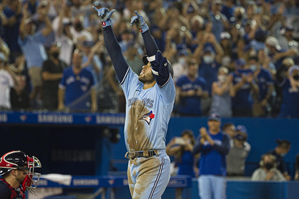 Toronto Blue Jays' George Springer (4) celebrates after hitting a home run during the eighth inning of a baseball game against the Boston Red Sox, Sunday, Aug. 8, 2021 in Toronto. (Christopher Katsarov/The Canadian Press via AP)