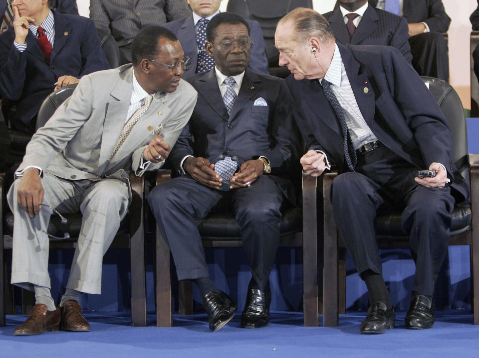 FILE- Chad President Idriss Deby, left, Equatorial Guinea President Teodoro Obiang Nguema Mbasogo, center, and French President Jacques Chirac, right, have a chat prior to the opening of the 23rd Africa-France summit in Bamako, Mali, Dec. 3, 2005.The era of France's arm-twisting interventionism in Africa may finally be over. France has sat by militarily despite moves by putschists to seize control of former French colonies in recent years. (AP Photo/Michel Euler, File)