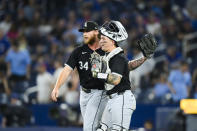 Chicago White Sox pitcher Michael Kopech (34) and catcher Korey Lee (26) celebrate the team's win over the Toronto Blue Jays in a baseball game Tuesday, May 21, 2024, in Toronto. (Christopher Katsarov/The Canadian Press via AP)