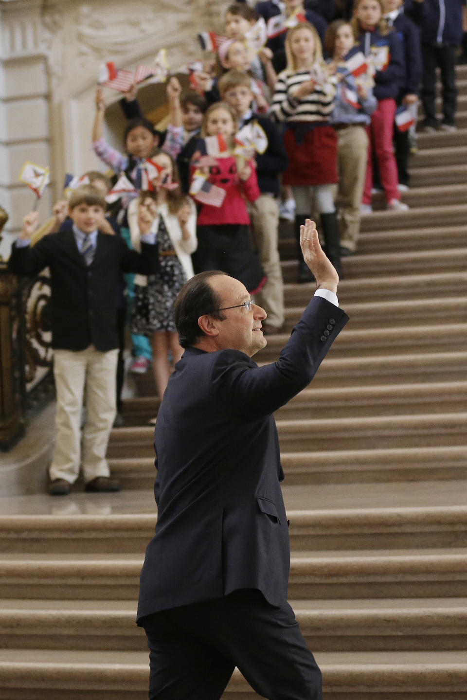 French president Francois Hollande waves as he arrives at city hall on Wednesday, Feb. 12, 2014, in San Francisco. The French president visited San Francisco to meet politicians, lunch with Silicon Valley tech executives and inaugurate a new U.S.-French Tech Hub. (AP Photo/Marcio Jose Sanchez)