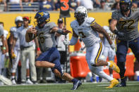 West Virginia quarterback Garrett Greene (6) rushes the ball against Towson during the first half of an NCAA college football game in Morgantown, W.Va., Saturday, Sept. 17, 2022. (AP Photo/William Wotring)