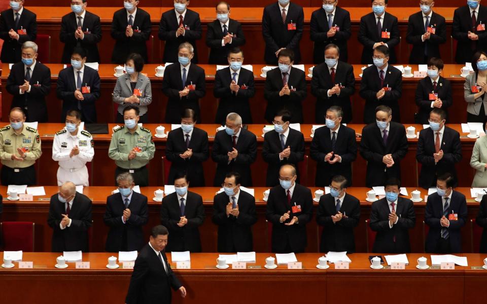 President Xi Jinping arrives for the opening session of the parliamentary session on Friday - Ng Han Guan/AP