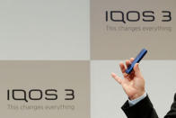 Philip Morris International's CEO Andre Calantzopoulos poses with the new IQOS 3 devices at a news conference in Tokyo, Japan, October 23, 2018. REUTERS/Kim Kyung-Hoon