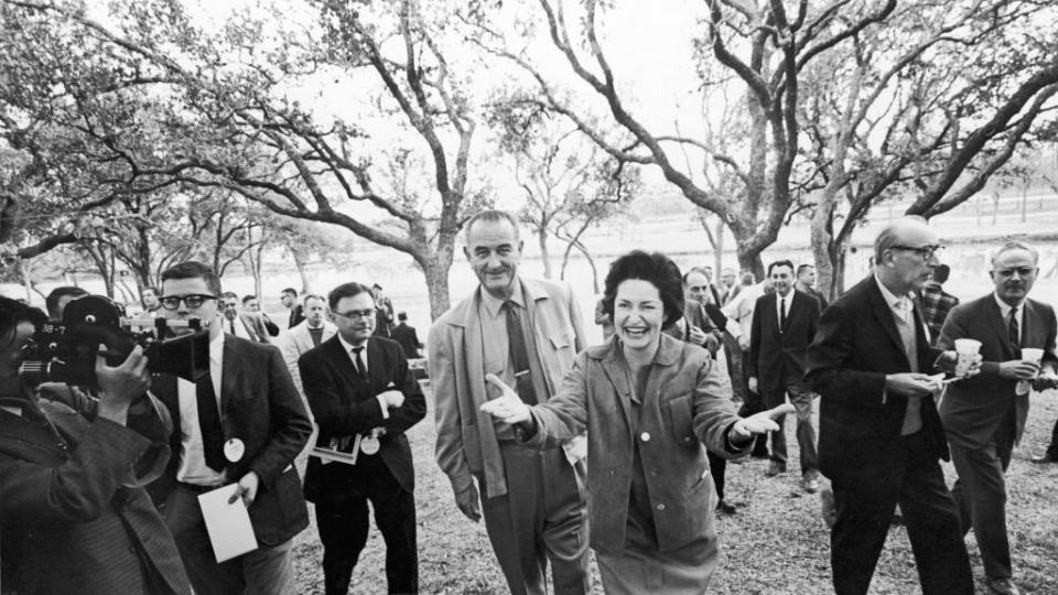 lyndon b johnson and wife lady bird surrounded by press members at their ranch in texas