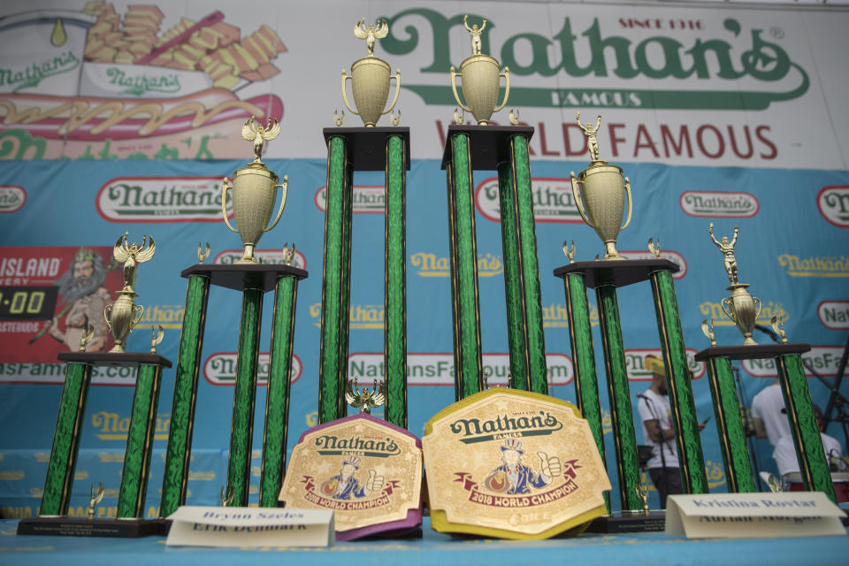<p>The trophies and champion belts are on display on stage ahead of the Nathan’s Famous Fourth of July hot dog eating contest, Wednesday, July 4, 2018, in New York’s Coney Island. (Photo: Mary Altaffer/AP) </p>