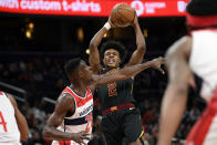 Cleveland Cavaliers guard Collin Sexton (2) handles the ball next to Washington Wizards center Ian Mahinmi (28) during the first half of an NBA basketball game Friday, Feb. 21, 2020, in Washington. (AP Photo/Nick Wass)