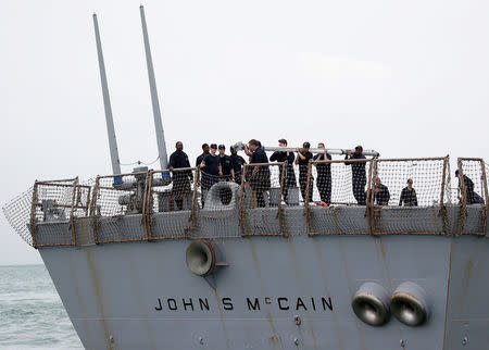 FILE PHOTO: Personnel work on the U.S. Navy guided-missile destroyer USS John S. McCain after a collision, in Singapore waters August 21, 2017. REUTERS/Ahmad Masood/File Photo