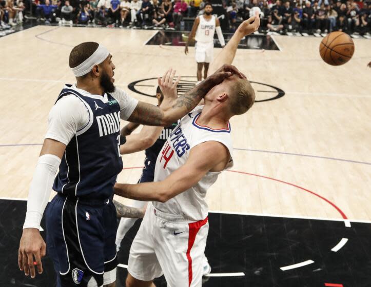 Los Angeles, CA, Wednesday, May 1, 2024 - Dallas Mavericks forward P.J. Washington (25) whacks LA Clippers center Mason Plumlee (44) in the face while battling for a rebound in game five of the NBA Western Conference playoffs at Crypto.Com Arena. (Robert Gauthier/Los Angeles Times)