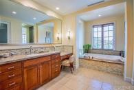 <p>The master bathroom features a double vanity and a deep soaker tub. (Trulia) </p>