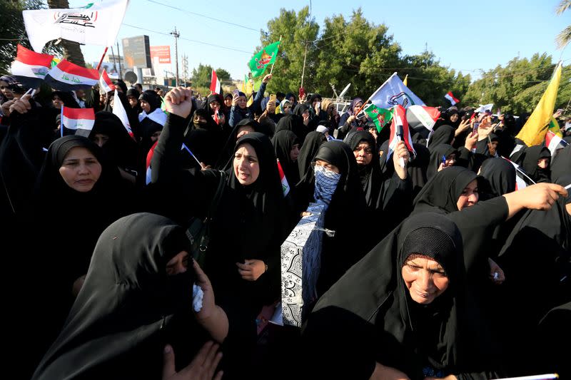 Women attend a funeral procession of Hashd al-Shaabi members in Baghdad