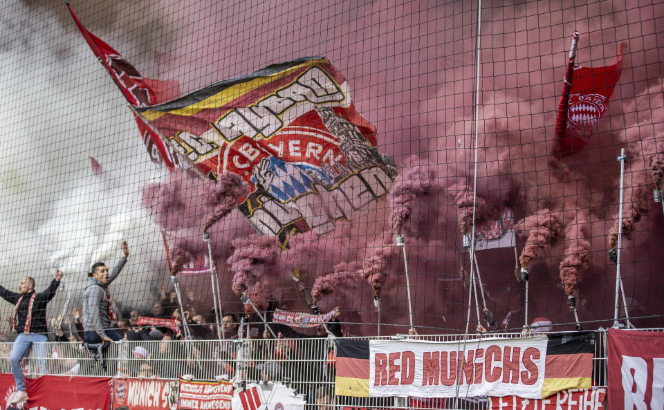 Bayern Munich fans set off smoke bombs during the German Bundesliga soccer match between FC Union Berlin and Bayern Munich at the An der Alten Forsterei stadium in Berlin, Germany, Saturday, April 20, 2024. (Andreas Gora/dpa via AP)