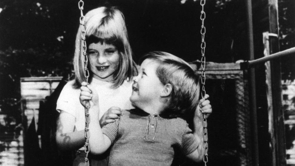 A young Princess Diana pushing her young brother Charles Spencer on a swing