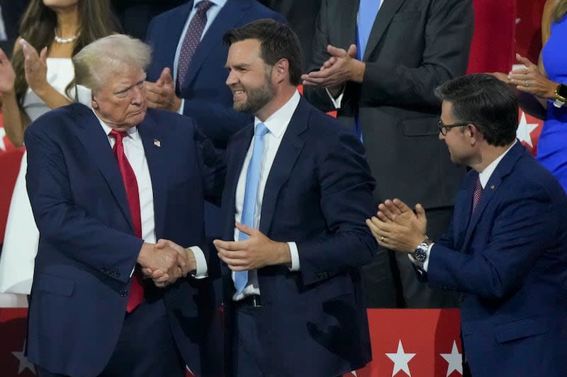 Republican presidential candidate former President Donald Trump shakes hands with Republican vice presidential candidate Sen. JD Vance, R-Ohio, during the Republican National Convention Monday, July 15, 2024, in Milwaukee. | Matt Rourke