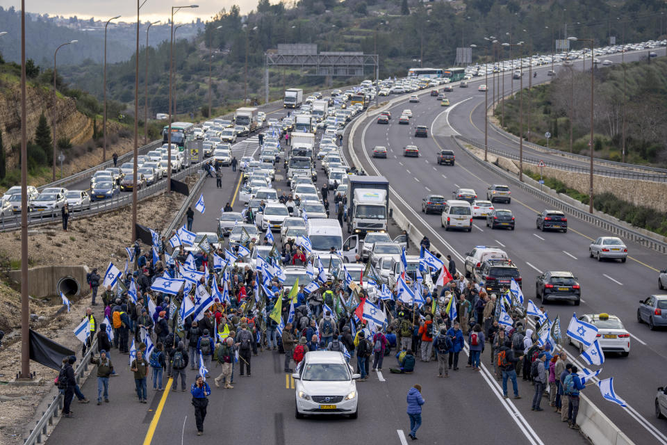 FILE - Israeli military reservists protest against the plans by Prime Minister Benjamin Netanyahu's new government to overhaul the judicial system, as they block the freeway from Tel Aviv to Jerusalem, Thursday, Feb. 9, 2023. A contentious judicial overhaul that is dividing Israel is tearing at the country's main unifying force: the military. Former top security officials are greenlighting insubordination in the face of what they say is impending regime change. And some reservists say they'll heed the call. (AP Photo/Ohad Zwigenberg, File)