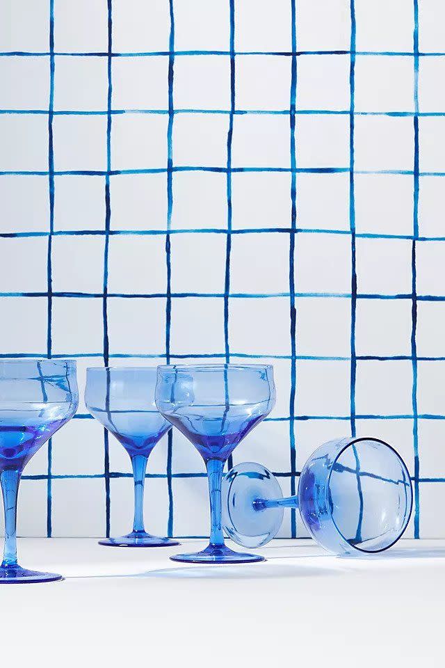 <p>Something about these glasses by American interior designer Mark D. Sikes conjures up cold rosé (or maybe a margarita) after a day on the beach in Montauk. We loved their easygoing charm and vivid azure hue. Set of four, £64, <a href="https://www.anthropologie.com/en-gb/shop/set-of-4-mark-d-sikes-wine-glasses?category=kitchen-glassware&color=043&type=REGULAR&size=Set+of+4&quantity=1" rel="nofollow noopener" target="_blank" data-ylk="slk:anthropologie.com" class="link ">anthropologie.com </a></p>
