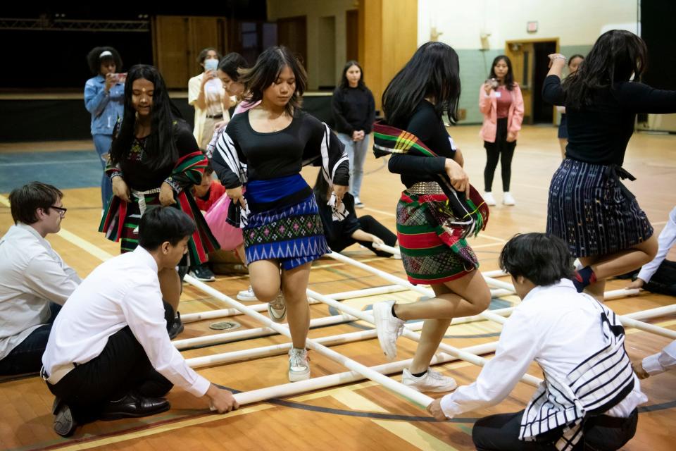 Lakeview students perform the traditional Burmese Chin bamboo dance during a youth multicultural exchange event at the Burma Center in Springfield, Michigan on Wednesday, April 27, 2022.