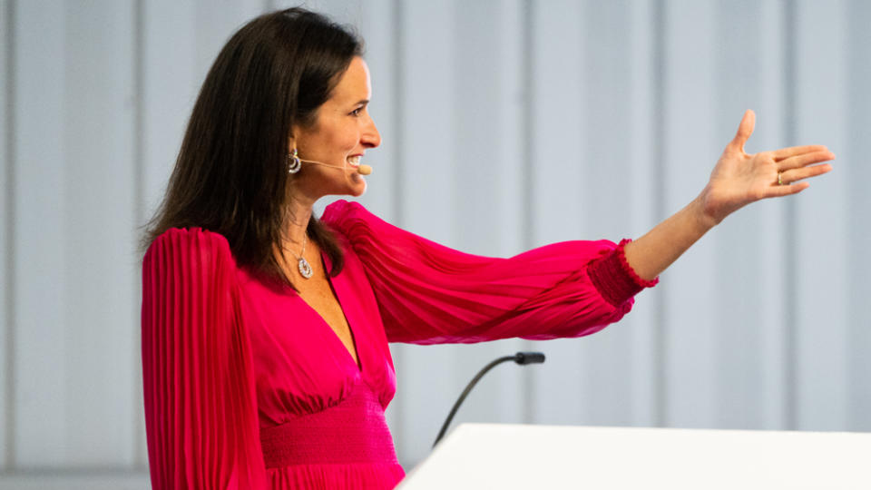 Lydia Fenet, principal auctioneer for Broad Arrow Auctions, manages the room at the 2022 Monterey Jet Center Auction.