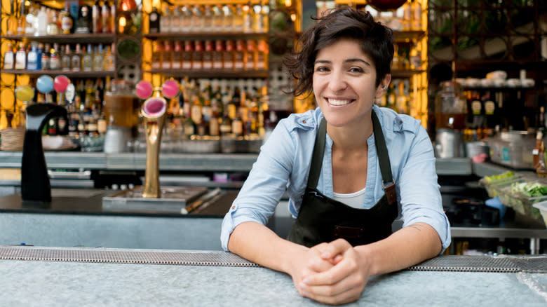 female bartender smiles at customers