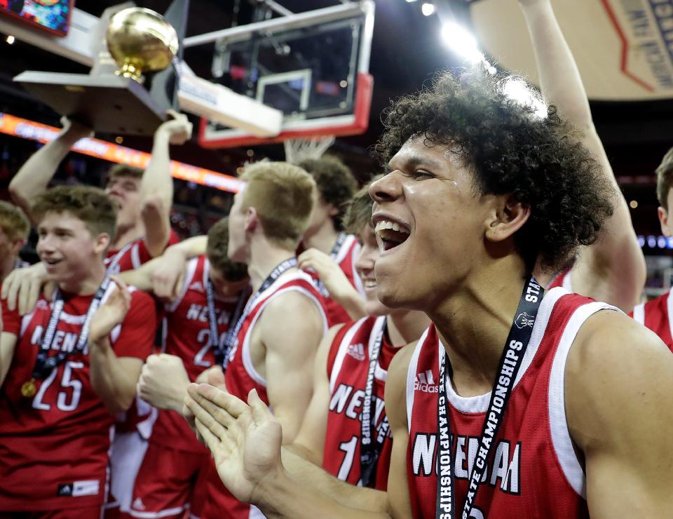 Neenah's Chevalier Emery Jr., right, celebrates the Rockets' victory over Brookfield Central in their WIAA Division 1 state championship boys basketball game March 19, 2022, at the Kohl Center in Madison. Neenah defeated Brookfield Central 64-52.