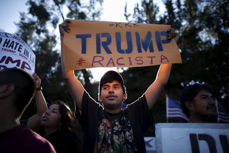 People protest outside the Luxe Hotel, where Republican presidential candidate Donald Trump was expected to speak in Brentwood, Los Angeles, California, United States July 10, 2015. REUTERS/Lucy Nicholson