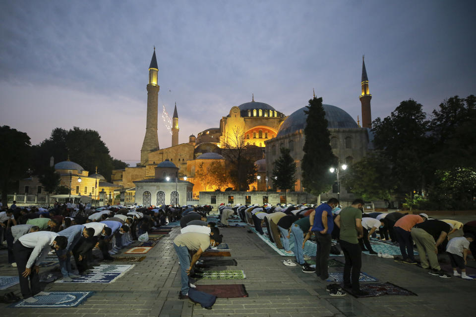 Muslims offer prayers during the first day of Eid al-Adha, outside the iconic Haghia Sophia in the historic Sultan Ahmed district of Istanbul, Tuesday, July 20, 2021. Thousands of Muslims attended dawn Eid al-Adha prayers in Istanbul. (AP Photo/Mucahid Yapici)