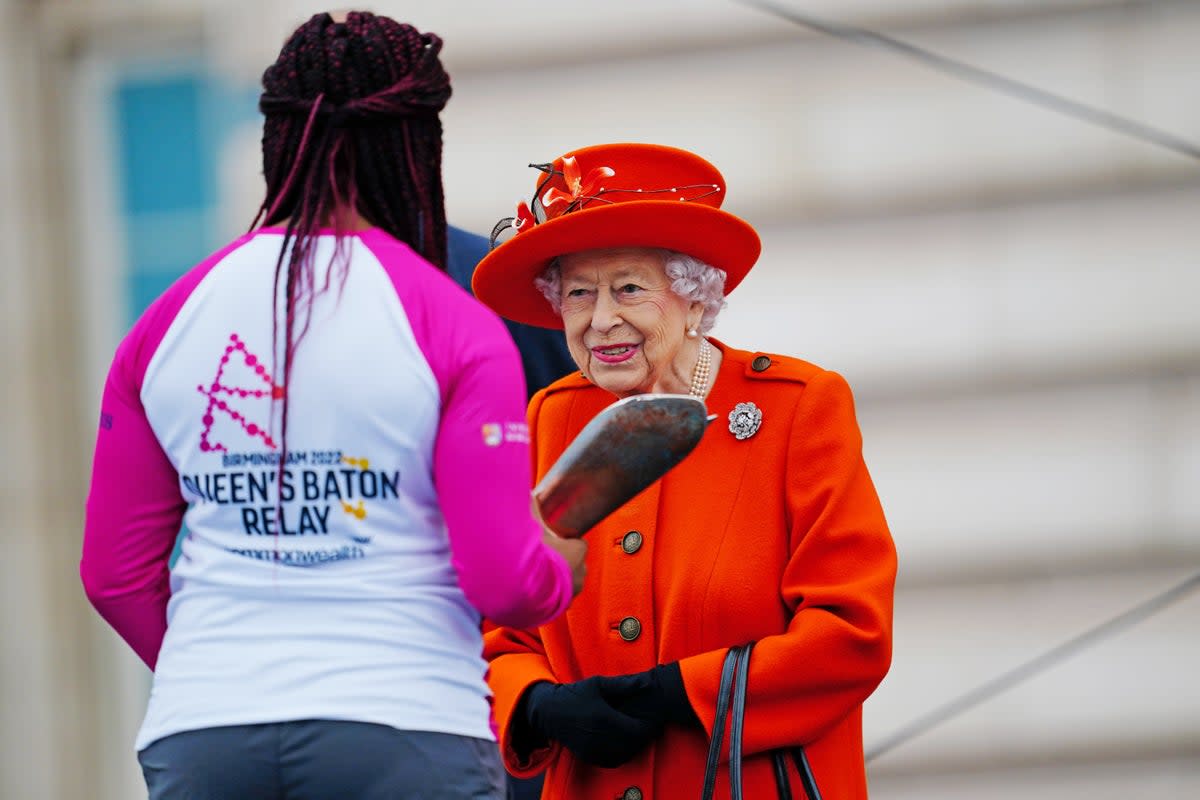 Queen Elizabeth II launched the 2022 Birmingham Commonwealth Games baton relay at Buckingham Palace, handing it to Kadeena Cox (left) (Victoria Jones/PA) (PA Archive)