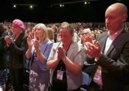 Prospective parliamentary Labour Party candidate, Tracy Brabin (2nd L), and other delgates applaud at the start of a minute set aside for the memory of murdered Labour MP Jo Cox on the first day of the Labour Party conference, in Liverpool, Britain September 25, 2016. REUTERS/Peter Nicholls