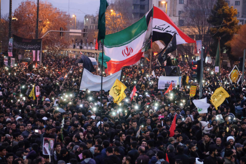 Iranians gather in the northeastern city of Mashhad on January 5, 2020 to pay homage to top general Qasem Soleimani and others after they were killed in a US strike. Source: Getty