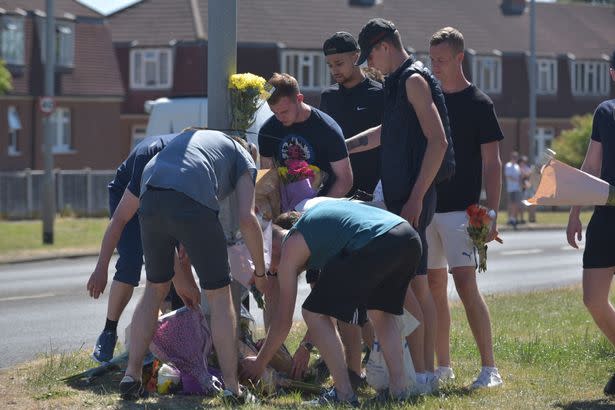 Friends and family of the dead youths lay flowers at the site of the crash. (SWNS)