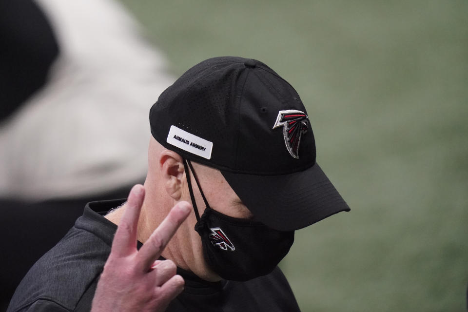 Atlanta Falcons head coach Dan Quinn gestures as he walks off the field after an NFL football game against the Carolina Panthers, Sunday, Oct. 11, 2020, in Atlanta. (AP Photo/Brynn Anderson)