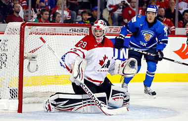Team Canada's goalie Mark Visentin, left, follows the play as Finland's Markus Granlund looks on during first period World Junior Championships bronze medal game hockey in Calgary, Alta., Jan. 5, 2012