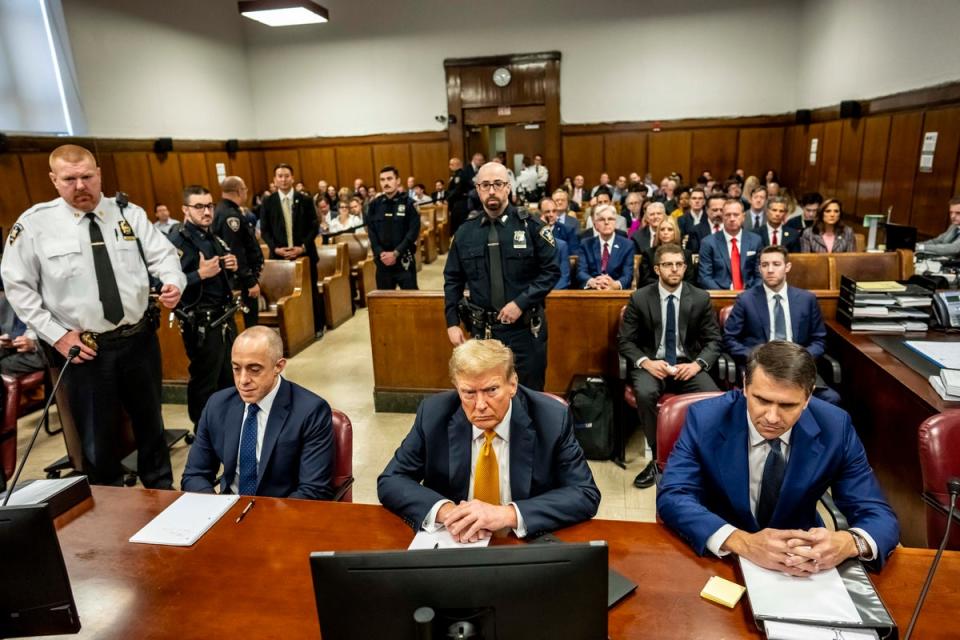Former President Donald Trump, center, sits in Manhattan Criminal Court with his attorneys Emil Bove, left, and Todd Blanche on May 21 (AP)