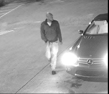 Police said the burglary suspect is driving a stolen red Mercedes Benz as seen in this surveillance-camera image.