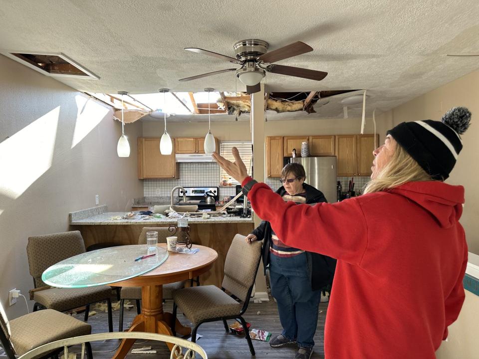 TJ Evans shows her landlord where she now has a skylight in her unit at the corner of Huff Street and Thomas Drive on Panama City Beach.