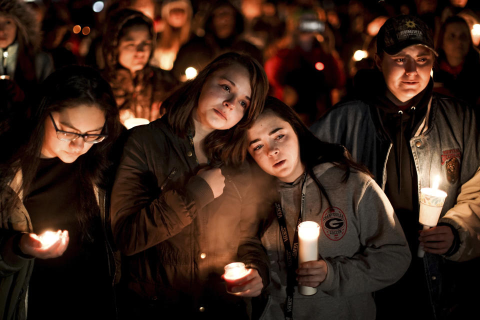 Caprice Cortez, Faith Goodsell, Autumn Barton and Mykaylla Darrow, all teammates on the Grantsville High School girls soccer team that Alexis Haynie played on, stand together at a candlelight vigil for the Haynie family at City Park in Grantsville, Utah, Monday, Jan. 20, 2020. Police say four members of the Haynie family were killed and one injured after being shot by a teenage family member on Jan. 17. (Spenser Heaps/The Deseret News via AP)