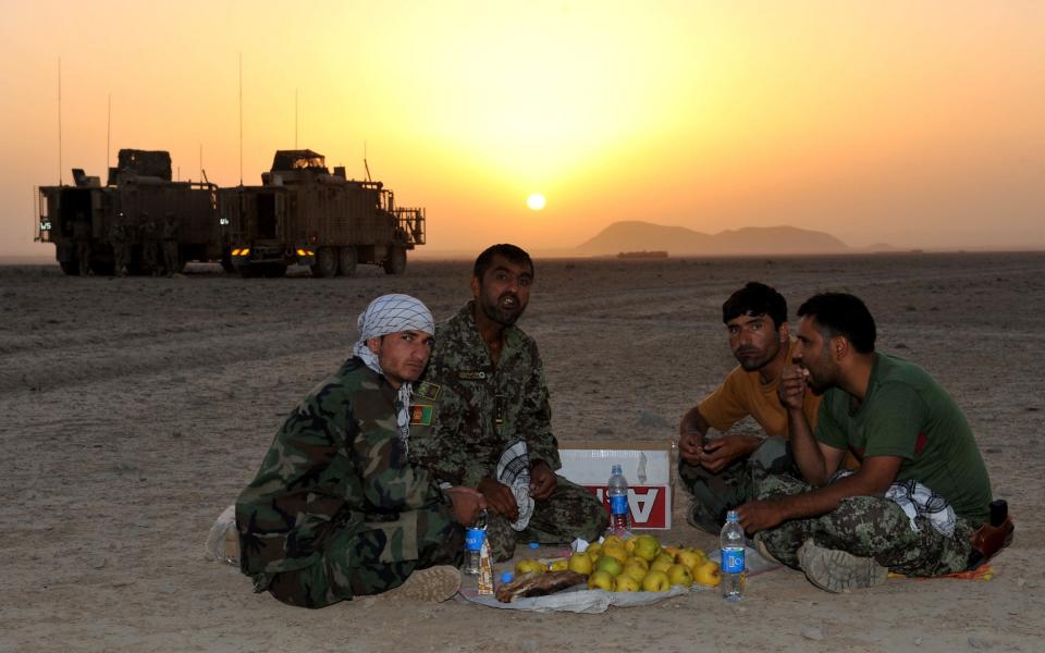 Afghan soldiers working and fighting alongside British forces, rest after a day's patrol through Helmand.  - Rupert Frere RLC/Crown Copyright