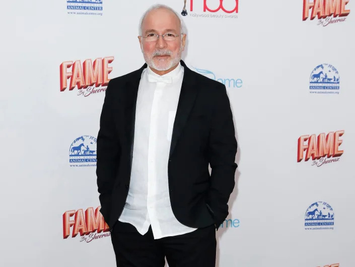 Enzo Angileri wears a black suit jacket and pants with a white shirt and sneakers at the 2020 Hollywood Beauty Awards at The Taglyan Complex on February 06, 2020, in Los Angeles, California.