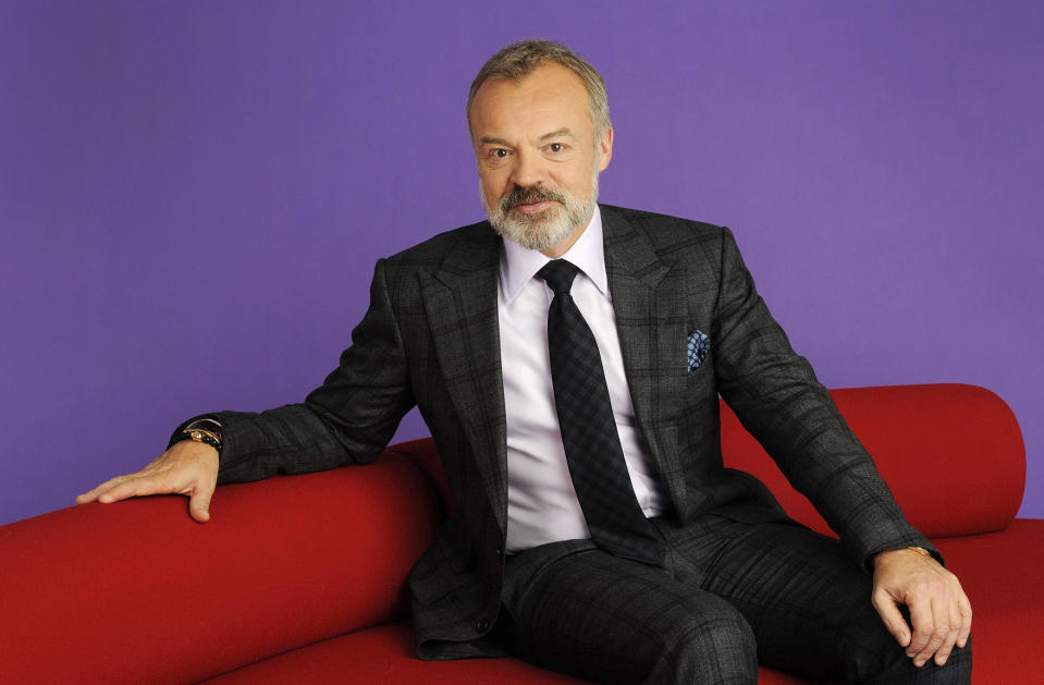 Guests squeeze onto Norton's iconic red sofa. (BBC)