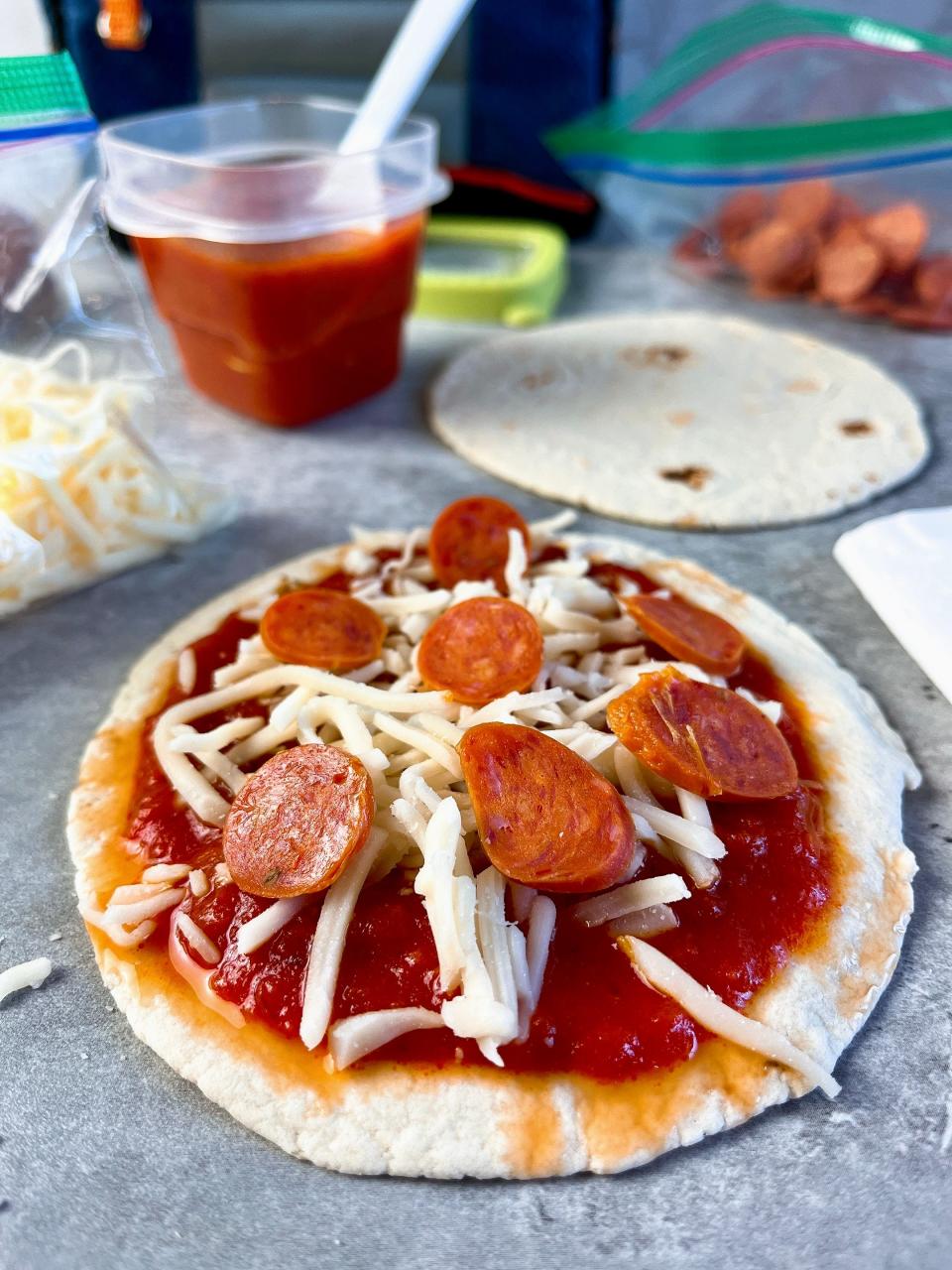 Spoon your favorite pizza sauce or marinara sauce onto street-taco-size flour tortillas. Top with shredded mozzarella cheese and mini pepperoni slices or regular sliced pepperoni. Pack these items separately so your child can assemble the pizzas at school. Way better than Lunchables!