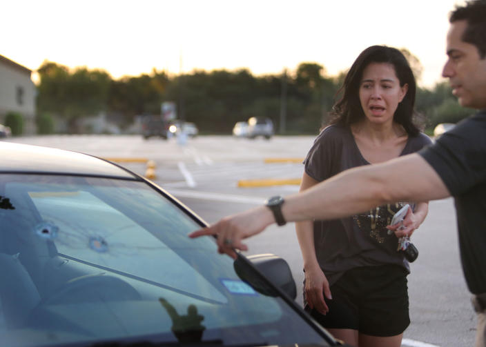 <p>Alan Wakim shows his wife, Jennifer Molleda, where two bullets entered his windshield and went past his face during a shooting along Wesleyan at Law Street in Houston that left multiple people injured and the alleged shooter dead, Sunday morning, Sept. 25, 2016, in Houston. (Mark Mulligan/Houston Chronicle via AP) </p>