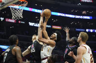 Cleveland Cavaliers center Jarrett Allen, center right, shoots while Los Angeles Clippers center Isaiah Hartenstein (55) defends during the first half of an NBA basketball game Wednesday, Oct. 27, 2021, in Los Angeles. (AP Photo/Marcio Jose Sanchez)