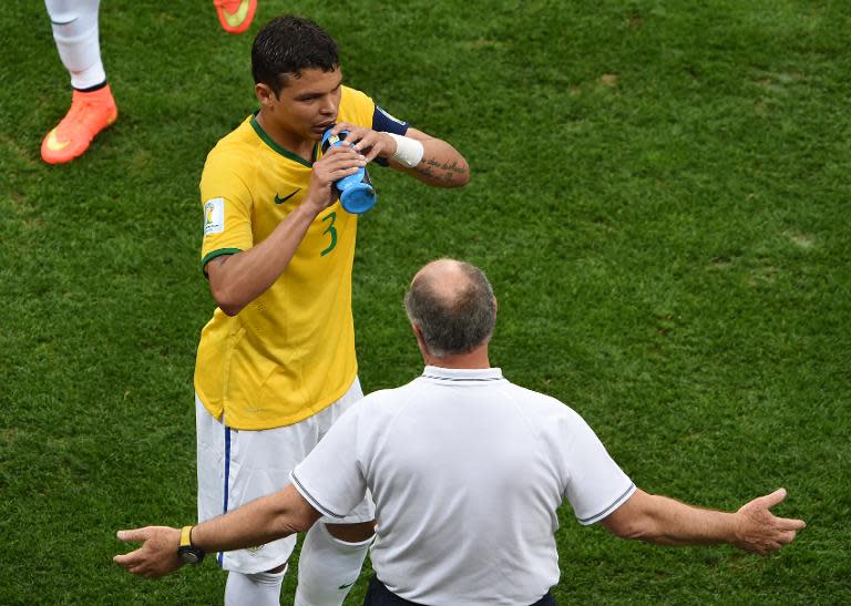 Brazil's captain Thiago Silva (L) drinks water as he speaks with Brazil's coach Luiz Felipe Scolari during the third place play-off match against the Netherlands during the 2014 FIFA World Cup at the National Stadium in Brasilia on July 12, 2014