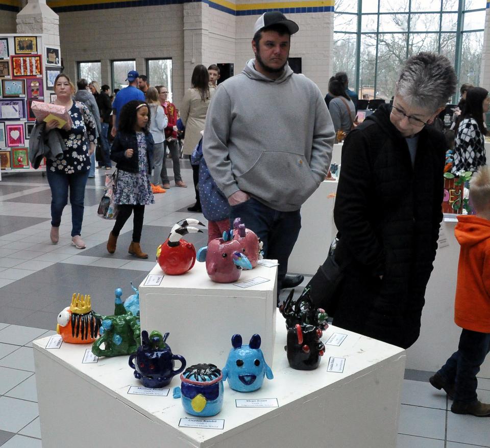 Spectators enjoys some of the art pieces on display Saturday at the annual Fine Arts Festival at Wooster High School.